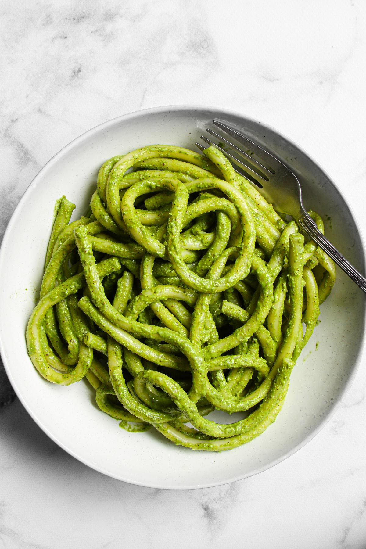 Spinach basil pesto pasta in bowl