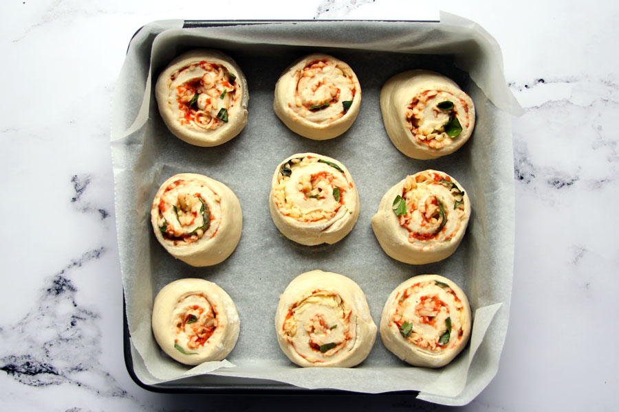Unbaked pizza rolls in pan