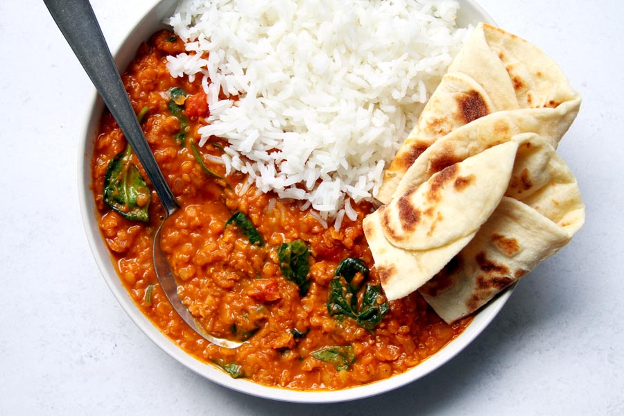 Bowl with dal, naan, and rice